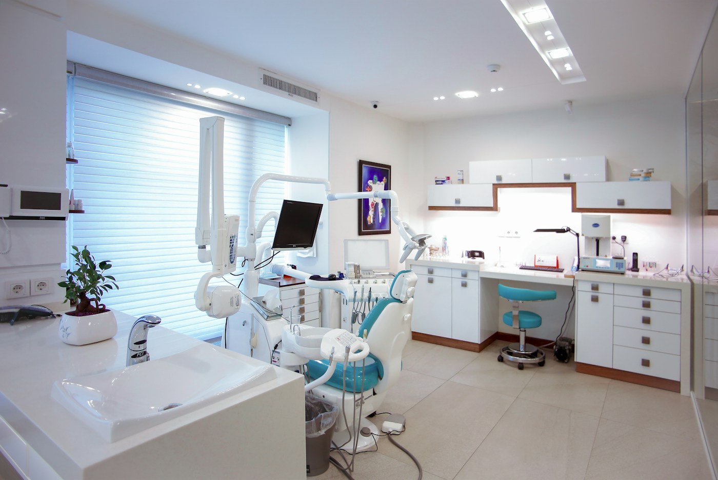 Bright contemporary dental practice with treatment chairs and large windows